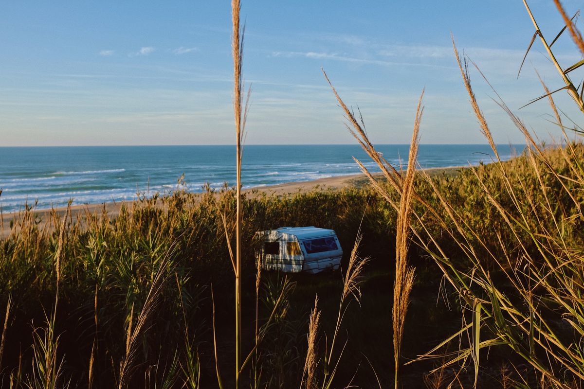 Campervan parked near a beach along Australia's east coast at sunrise