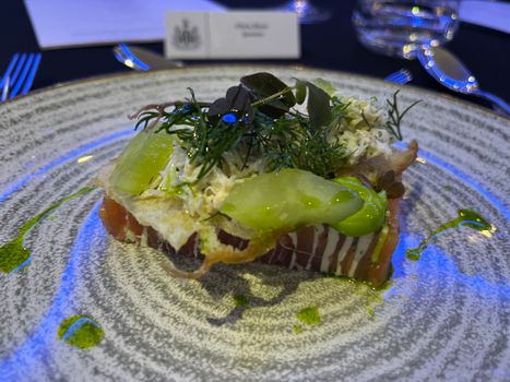 Delicious gourmet salmon dish served with greens and a touch of sauce.