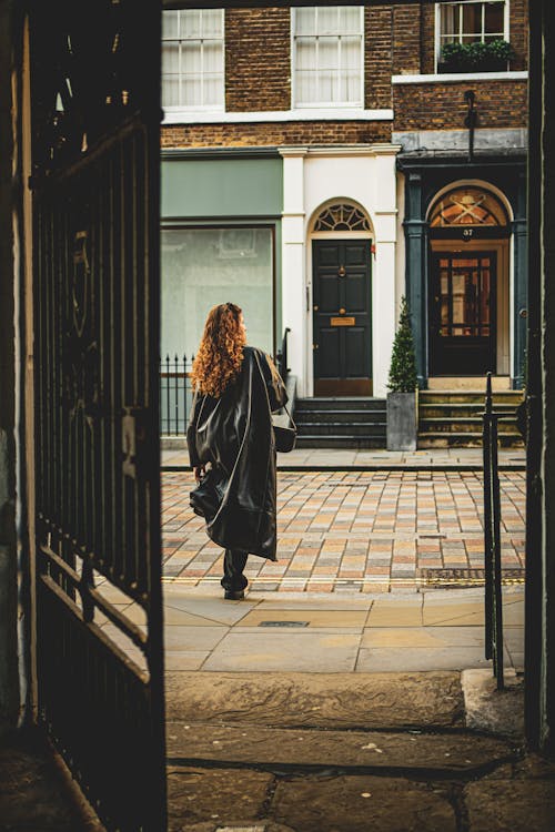 A woman walking through an open door in a city