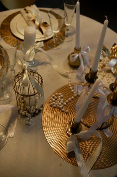 Chic table decor with candles, pearls, and elegant glassware. Perfect for special occasions.