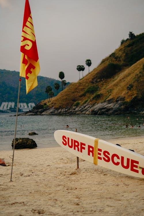 Flag and Rescue Surfboard on Beach