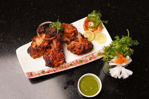 A plate with chicken and vegetables on it