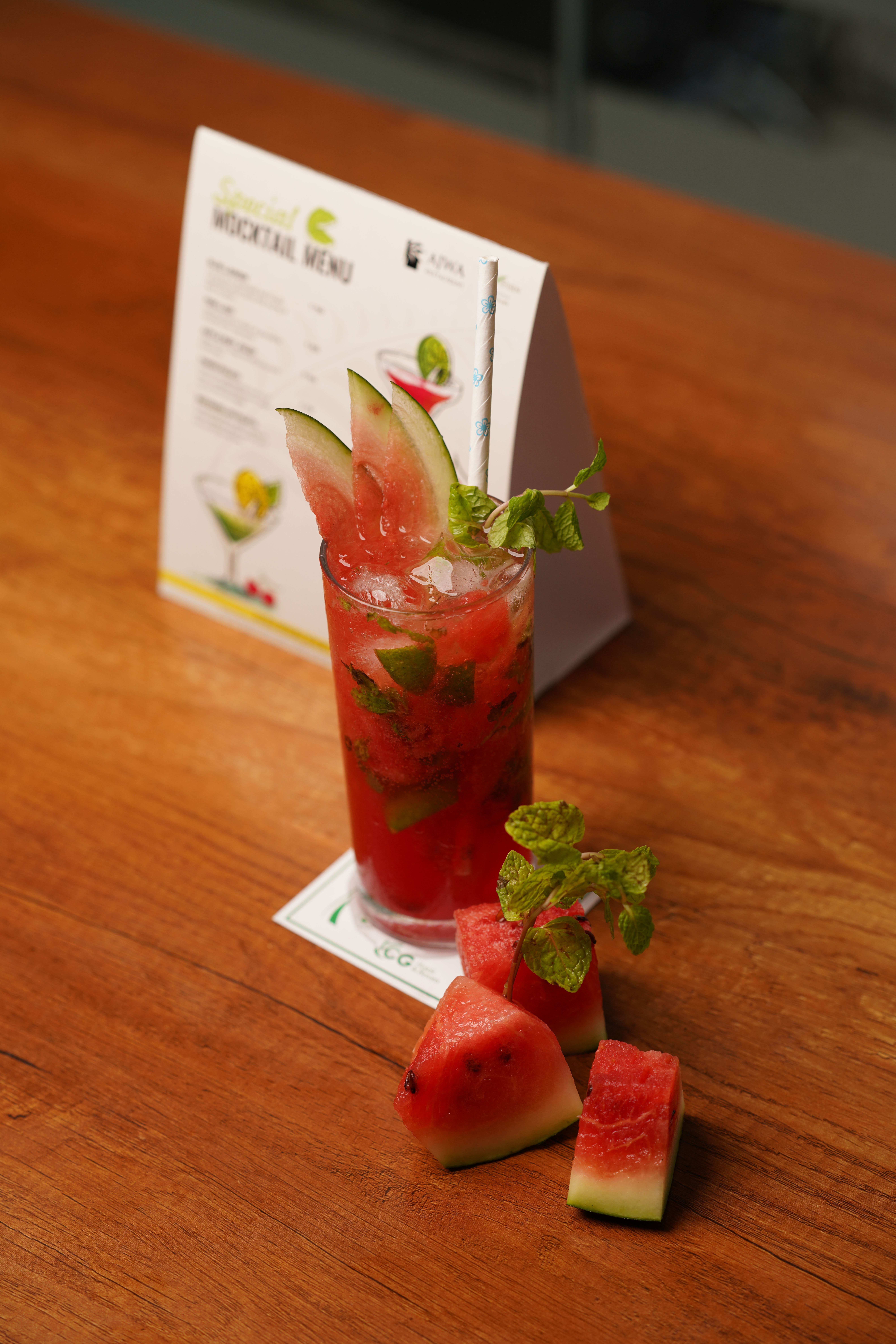 Vibrant watermelon mocktail with fresh mint garnish on a light background