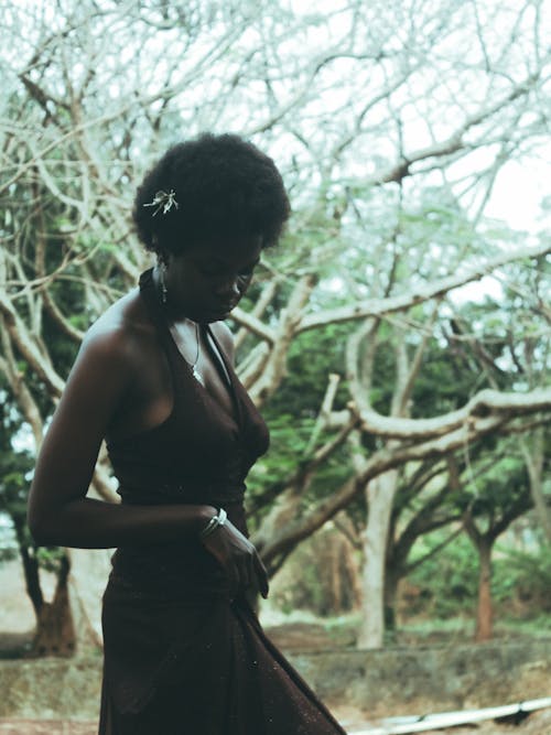 A woman in a dress walking in the woods