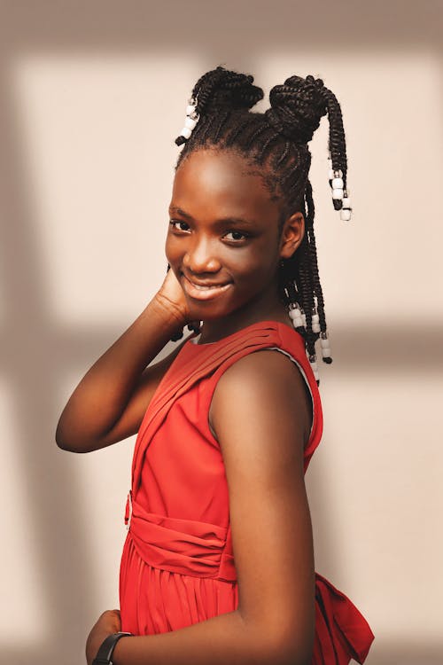 A young woman with dreadlocks in a red dress