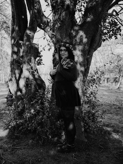 A woman standing in front of a tree
