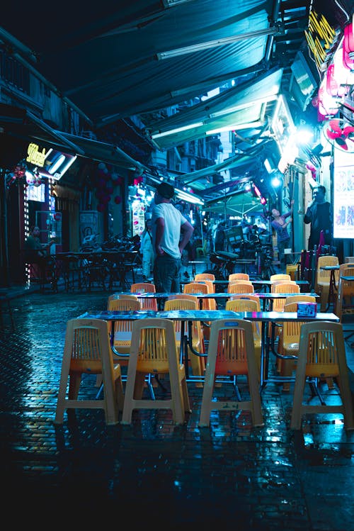 A street with tables and chairs in the rain