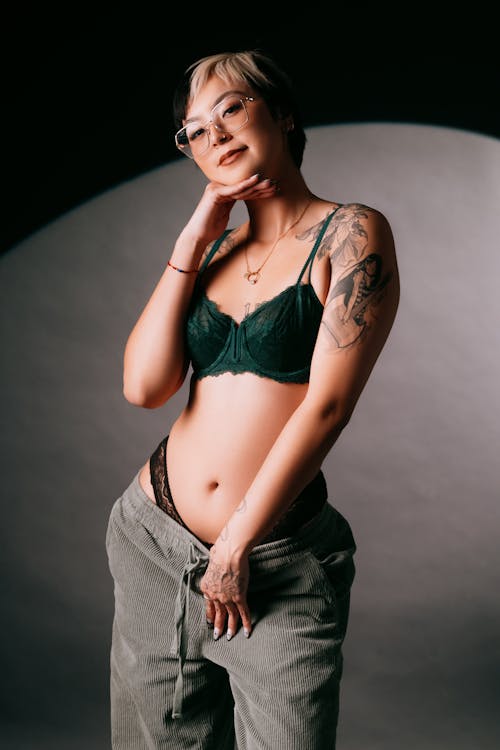 A woman in a green bra and pants posing for a photo