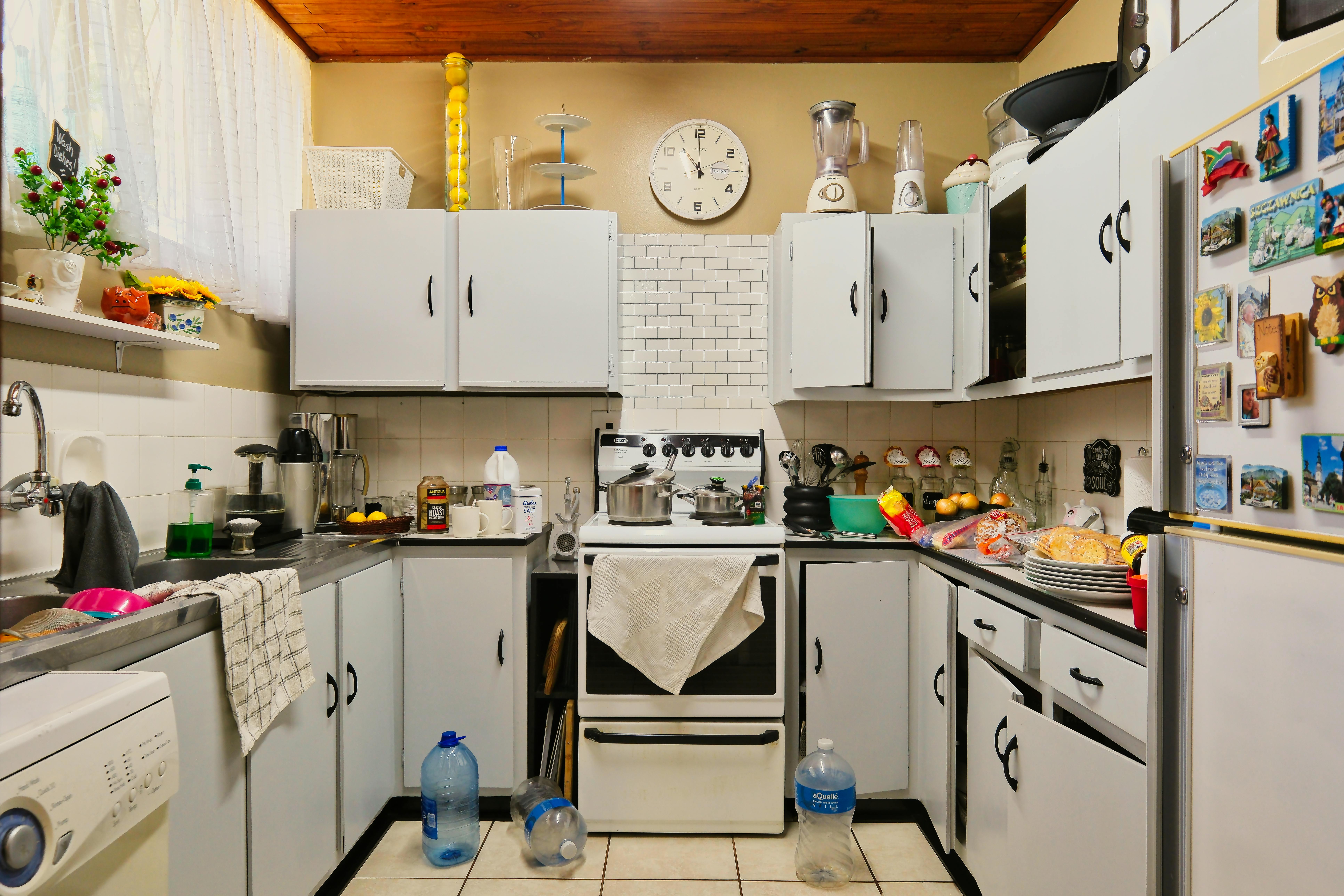 A homey and cluttered kitchen setup with appliances and decor.