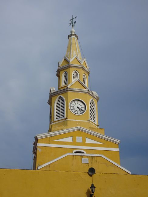 Discover the historic Torre del Reloj in Cartagena, an iconic landmark with its vibrant yellow facade.