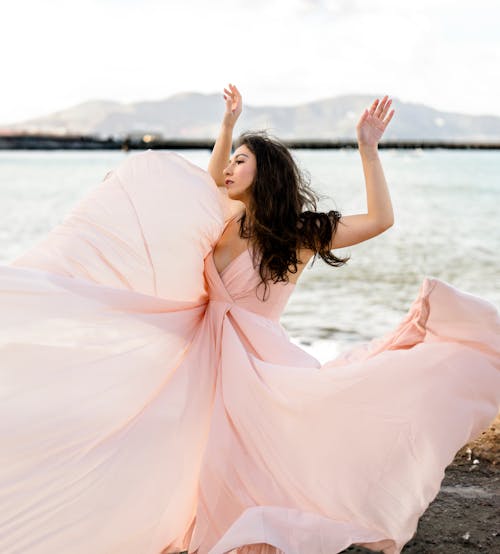 Woman Posing In a Long Dress Flowing In the Wind