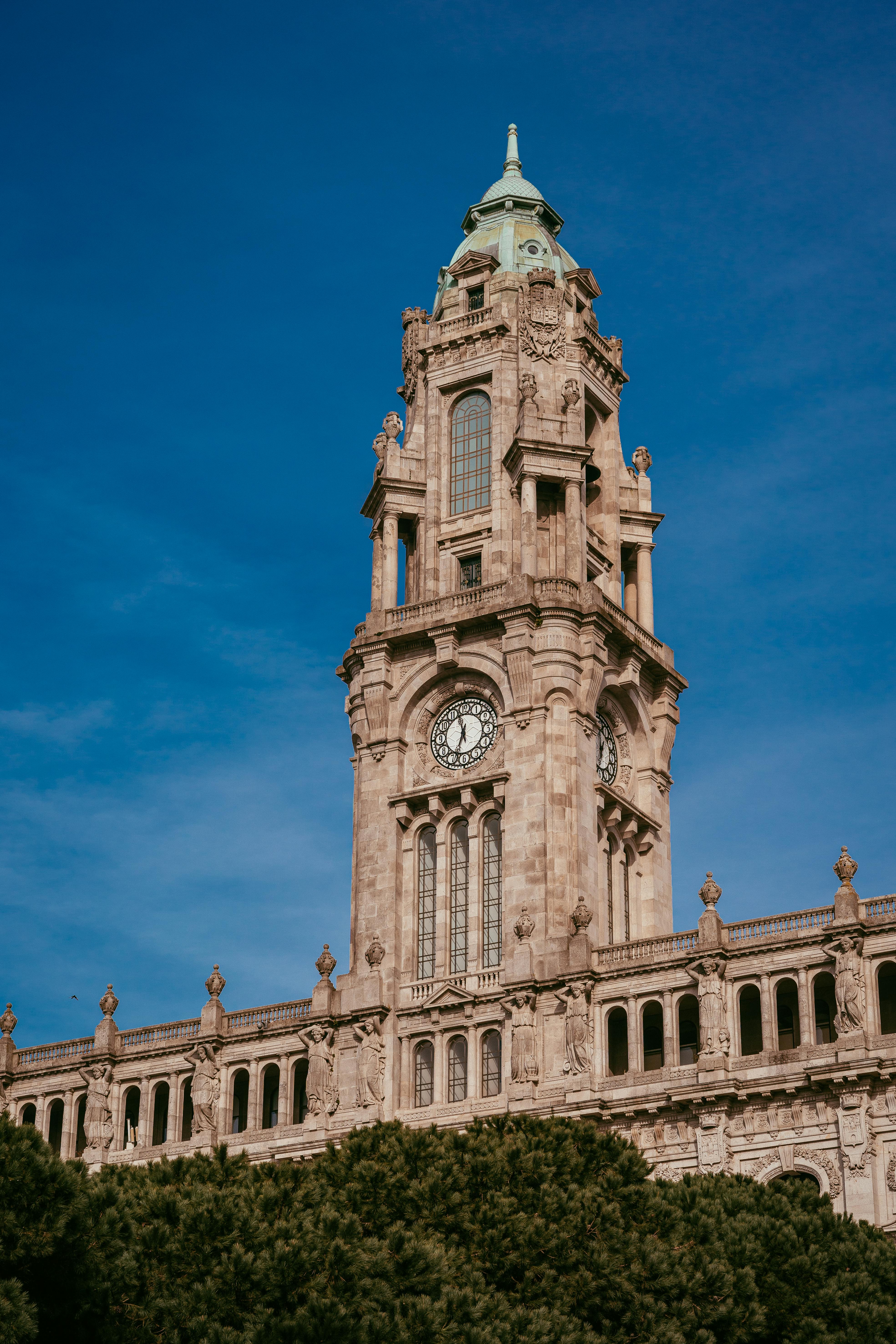 Historic Torre dos Clérigos against clear blue skies in Porto, Portugal.
