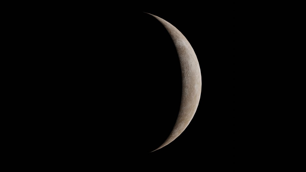 high resolution image of a crescent moon set against a black backgroun