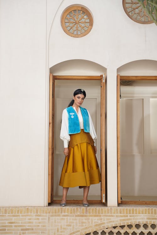 Woman Standing in Traditional Vest and Dress