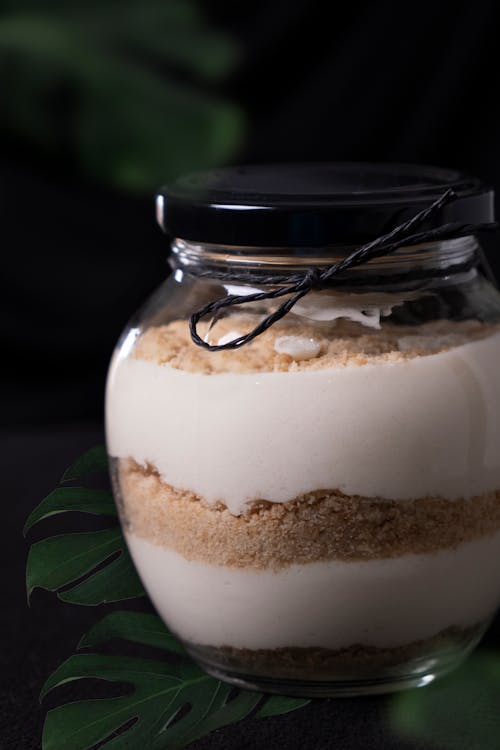 A jar of white cake with coconut and cream