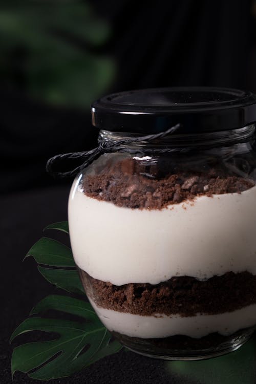 A jar filled with chocolate and white cake