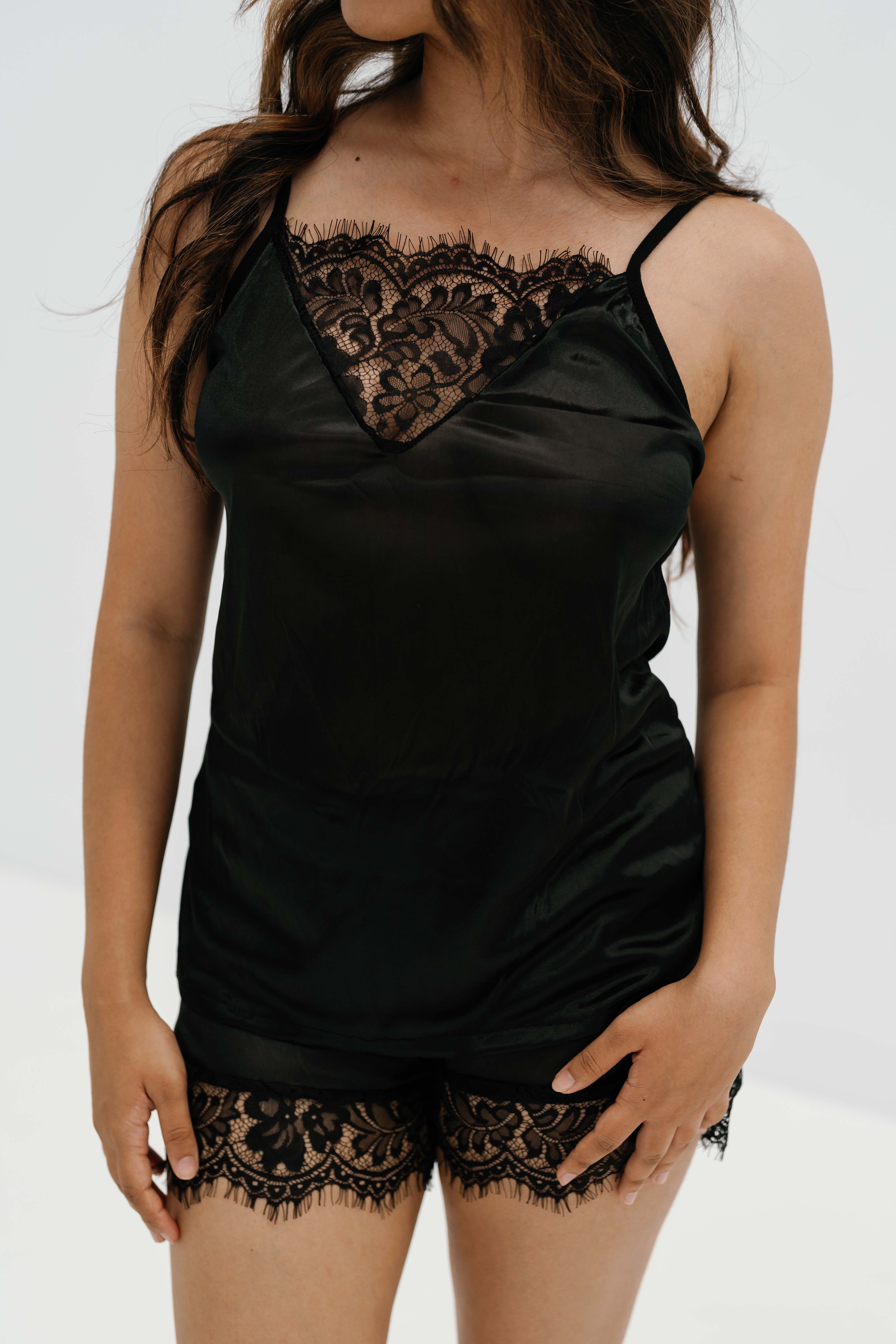 Black lace camisole on a studio background — Sensory Soft on Pexels