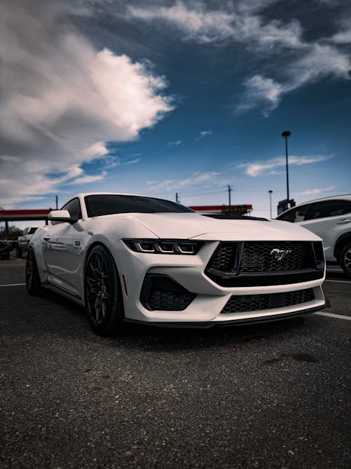 The front end of a white mustang car