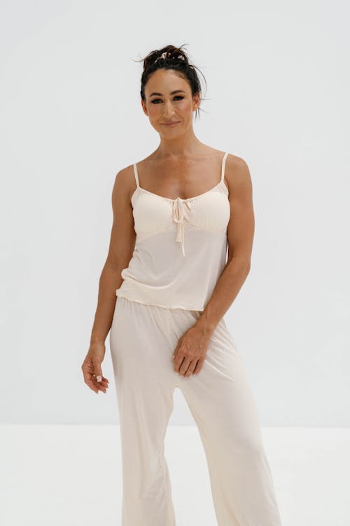 Free Model in White Pajamas with Spaghetti Strap Top Posing in the Studio Stock Photo