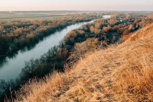 A view of a river and grassy hills