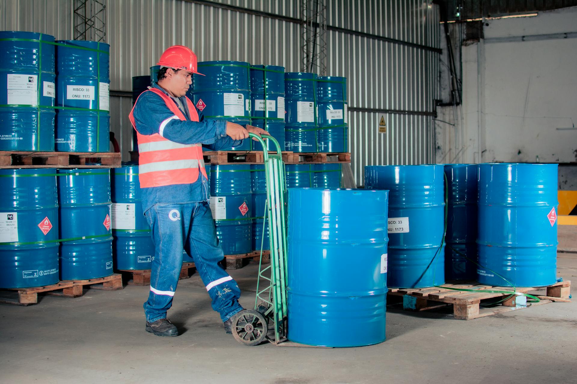 Worker in Warehouse with Barrels