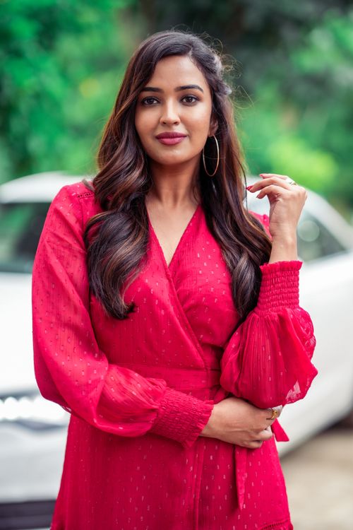 Free Stunning portrait of a brunette woman in a vibrant red dress outdoors, exuding elegance. Stock Photo