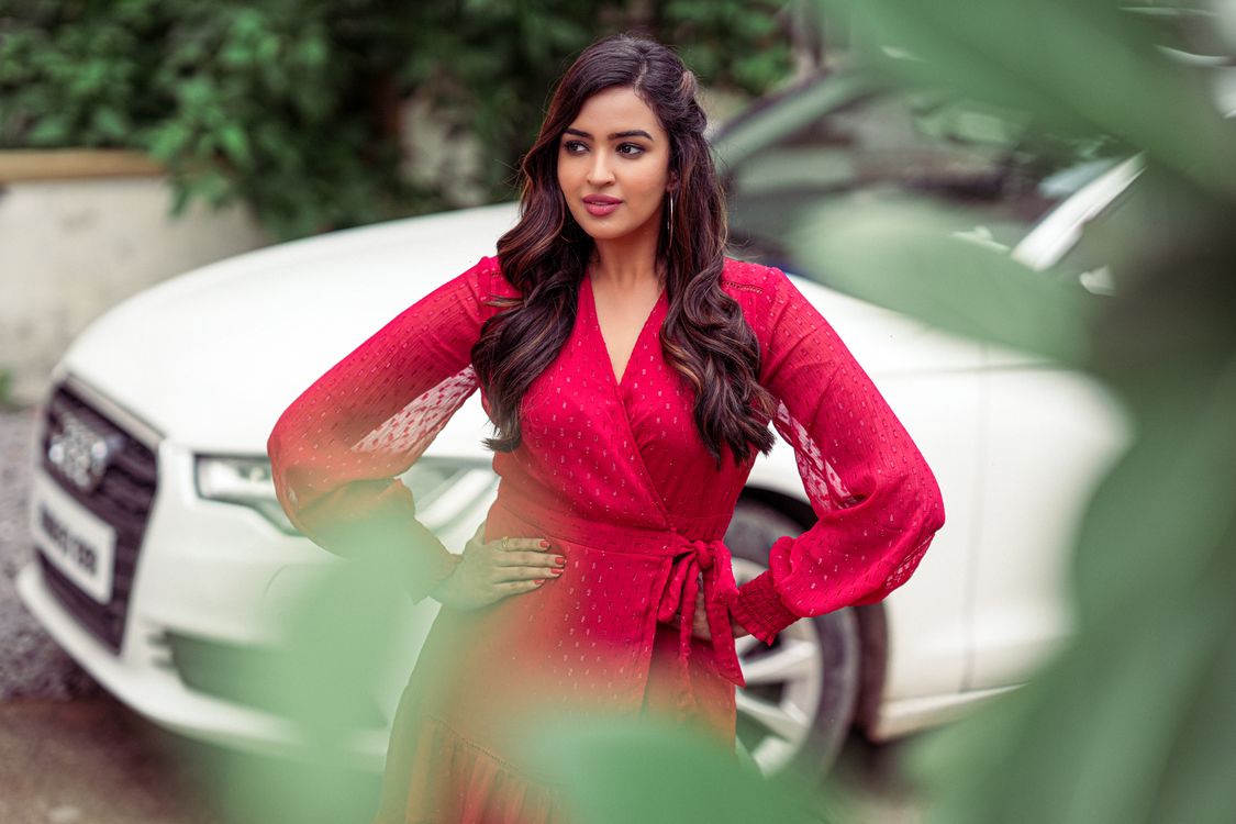 Young Brunette in a Red Dress Standing near a White Car · Free Stock Photo