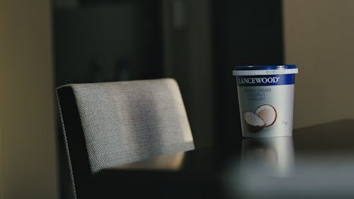 A cup of coconut milk sits on a table