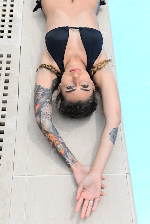 Woman Wearing Bikini Lying by the Swimming Pool