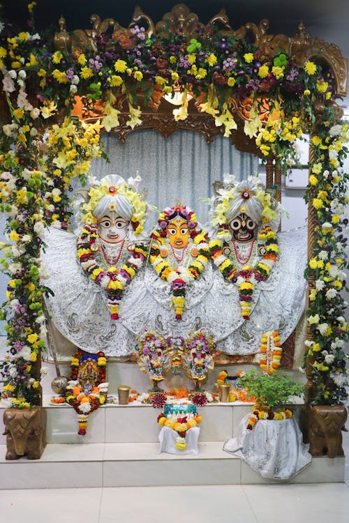 A shrine with flowers and garlands on it