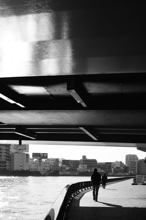 Free Black and White Photo of People Walking under a Bridge in City  Stock Photo