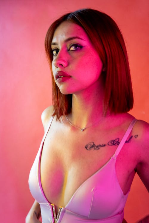 A woman with tattoos on her chest and neck