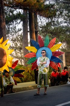 Colorful costumes and decorations at a festival parade in Baguio City, Philippines.