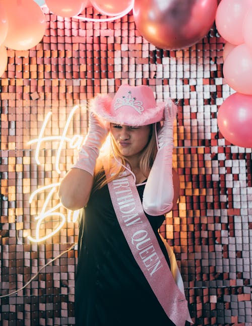 Woman in Pink Hat and in Dress for Birthday Party