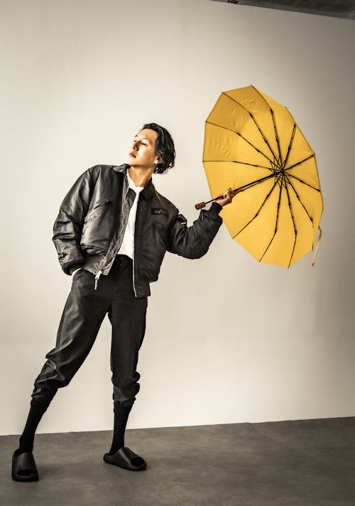 Man in Leather Jacket Posing with Umbrella