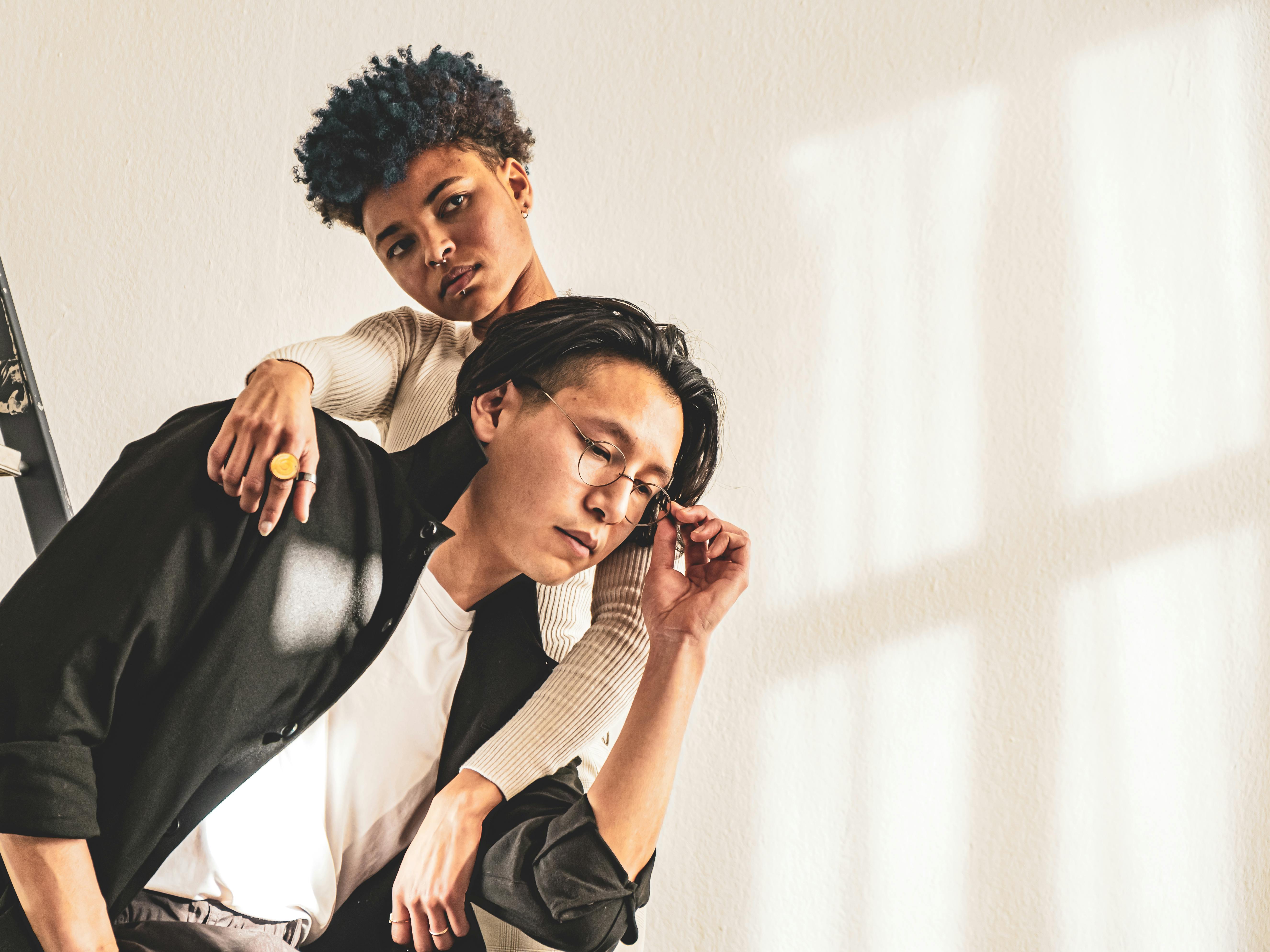 A man and woman sitting on a ladder
