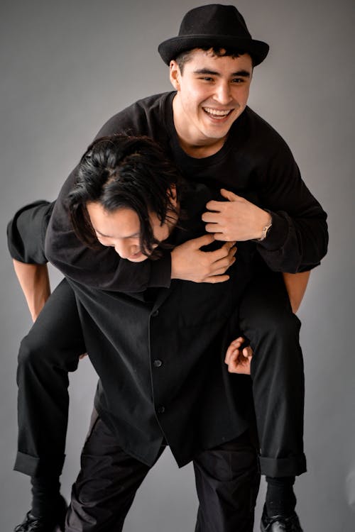 Smiling Men in Black Clothes and Hat