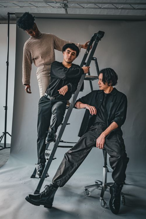 Free Stylish models posing with ladder in a Berlin studio, showcasing modern fashion trends. Stock Photo