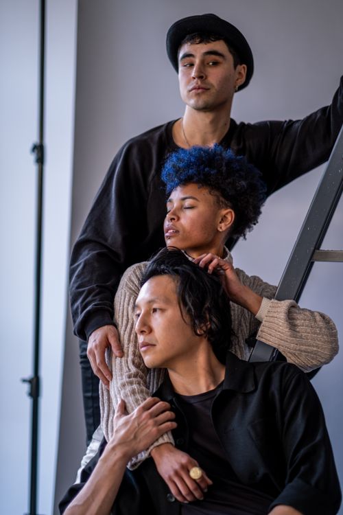 Free Portrait of three diverse models posing casually on a ladder in a Berlin studio. Stock Photo