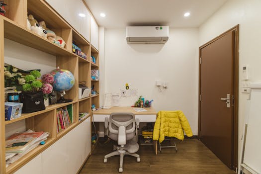 A modern home office featuring organized wooden shelves, a desk, and a vibrant yellow jacket.