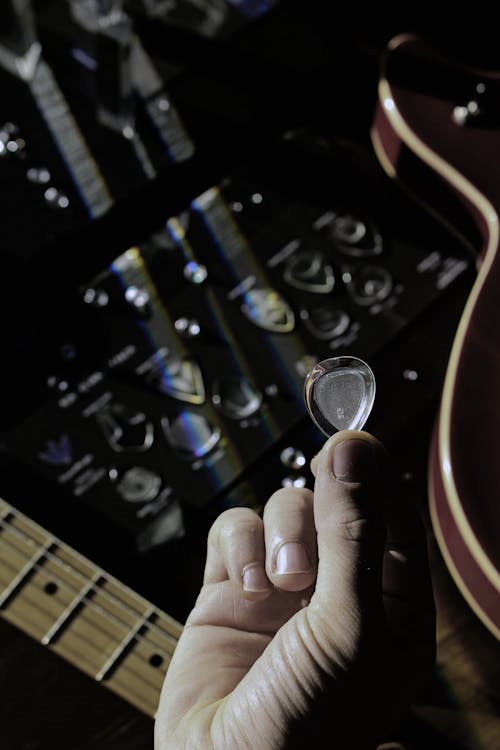 Man Hand Holding Guitar Pick