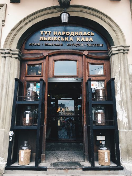 Free Rustic entrance of a coffee shop in Lviv, Ukraine, featuring classic wooden doors. Stock Photo