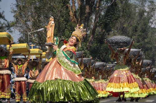 Woman in Traditional Clothing with Figurine of Virgin Mary in Festival