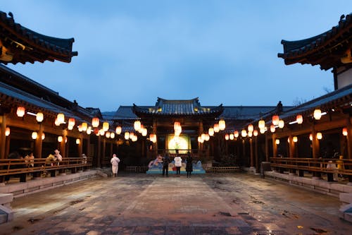 A courtyard with lanterns and lanterns hanging from the ceiling