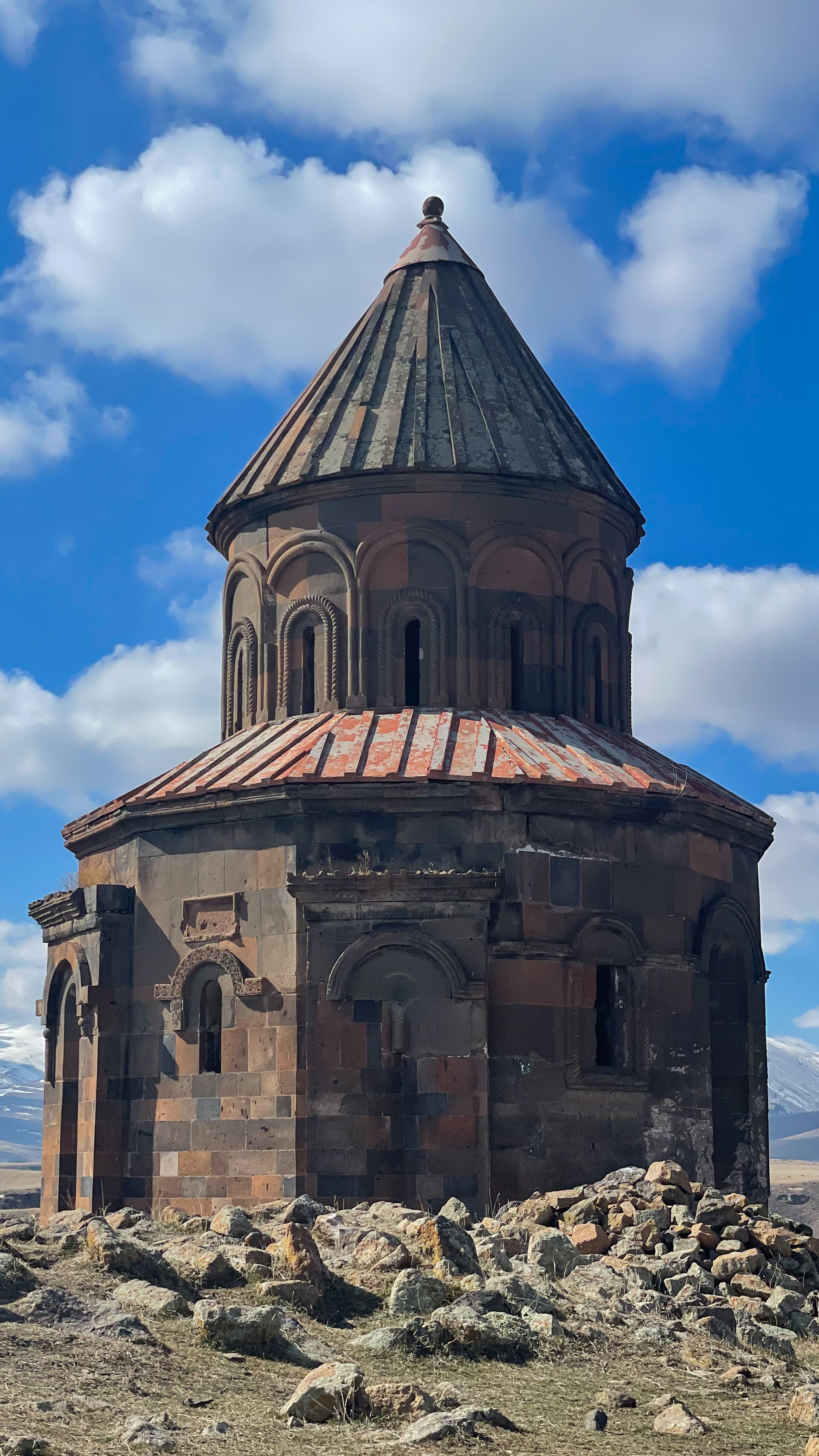 Ancient stone church in Ani, Kars, Turkey with blue sky backdrop.