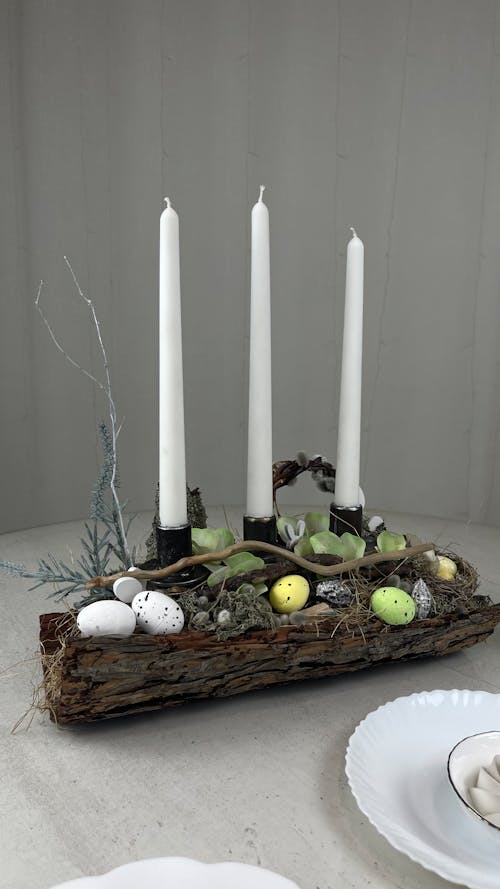 A table with candles and eggs on it