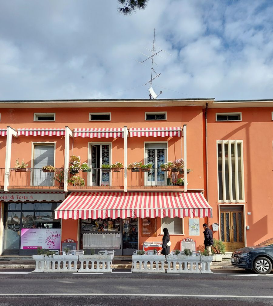 Stock photo of a clean storefront with red and white striped awnings