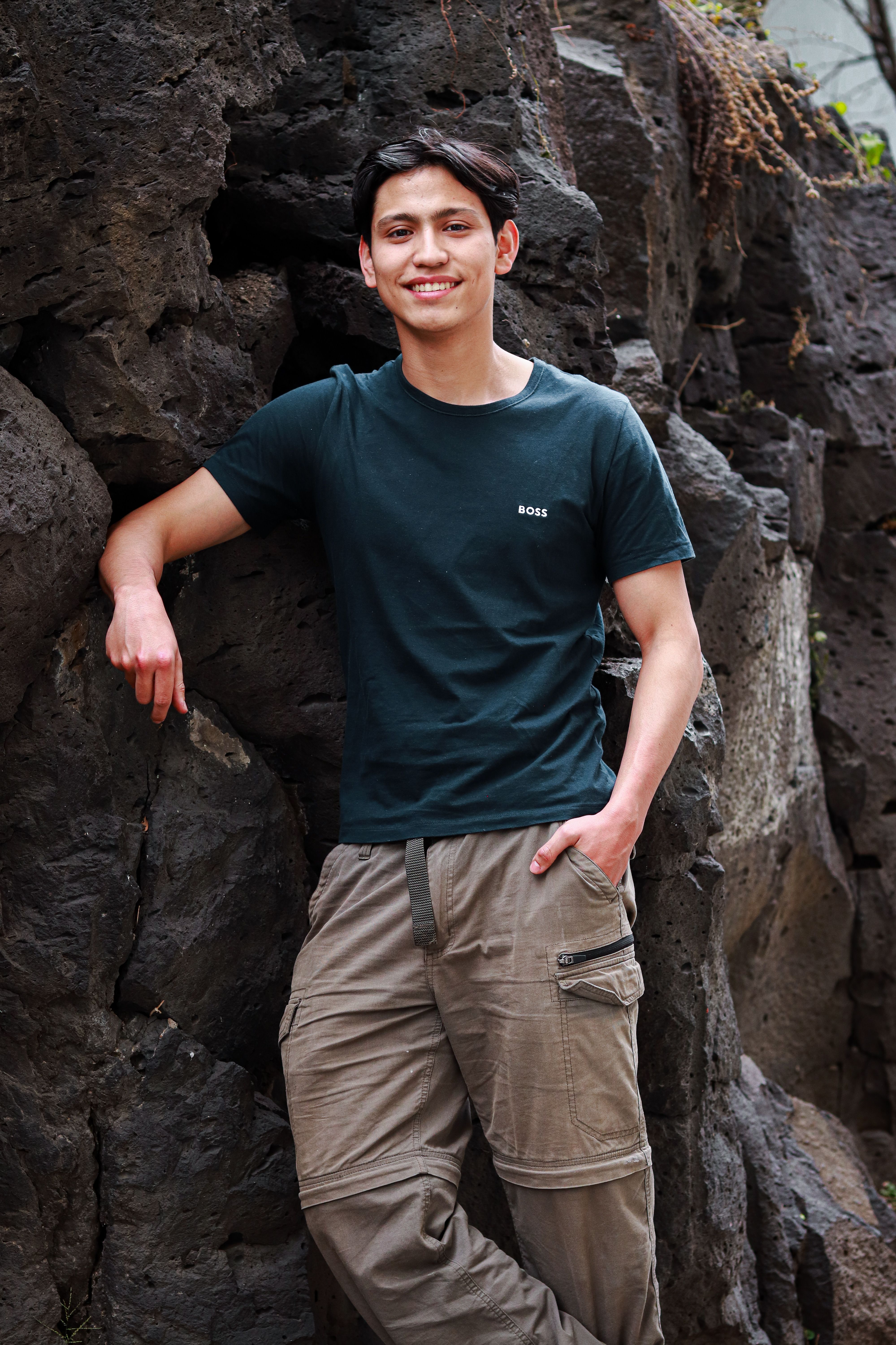 Smiling man posing outdoors against rock background in Ciudad de México.