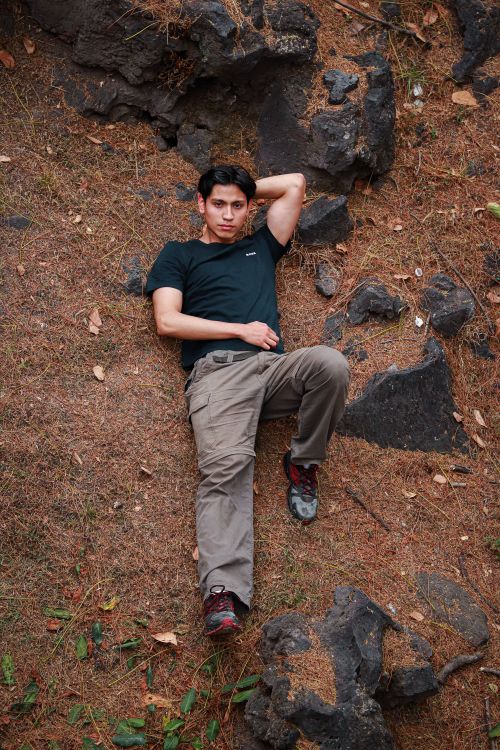 Free Young man in black t-shirt lying on a rocky ground, Ciudad de México Stock Photo