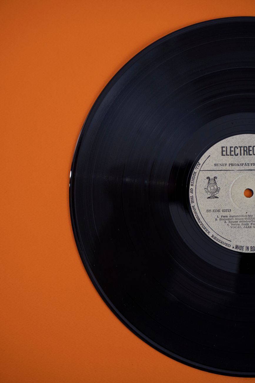 Slow Burn album cover art, burnt-orange sunburst on cream